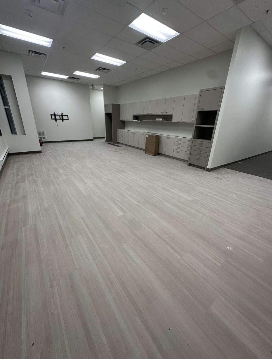 Commercial office LVP wood-look flooring installation in Toronto — seamless light oak plank finish